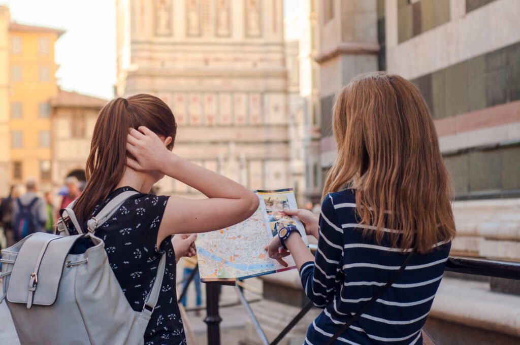 Two,Girls,Consulting,A,Map,In,Florence,,Italy